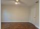 This bedroom offers wood flooring and a lighted ceiling fan at 13546 Summerton Dr, Orlando, FL 32824