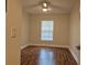 Cozy bedroom featuring hardwood floors, neutral walls, a ceiling fan, and a window for natural light at 13546 Summerton Dr, Orlando, FL 32824