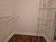 Walk-in closet features custom shelving and laminate flooring at 13546 Summerton Dr, Orlando, FL 32824