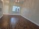 Spacious living room with hardwood floors, chandelier lighting, and open view of the kitchen, great for entertaining at 13546 Summerton Dr, Orlando, FL 32824