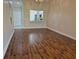 The large open living room features wood flooring and overlooks the kitchen and front door at 13546 Summerton Dr, Orlando, FL 32824