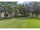 Spacious backyard features mature trees and a partial view of the home at 13850 Amelia Pond Dr, Windermere, FL 34786