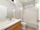 Well-lit bathroom featuring a bathtub with shower, neutral tile flooring, and modern fixtures at 13850 Amelia Pond Dr, Windermere, FL 34786