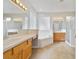 Spacious bathroom with double vanity, soaking tub, tiled floors, and ample counter space at 13850 Amelia Pond Dr, Windermere, FL 34786