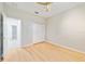 Comfortable bedroom with light wood floors, a ceiling fan, and closet, creating a welcoming space at 13850 Amelia Pond Dr, Windermere, FL 34786