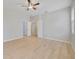 Spacious bedroom with light wood floors and a ceiling fan for added comfort at 13850 Amelia Pond Dr, Windermere, FL 34786