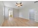 Bedroom featuring light wood floors, ceiling fan, and ensuite bath access at 13850 Amelia Pond Dr, Windermere, FL 34786