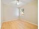 Inviting bedroom with light wood floors, a ceiling fan, and a bright window at 13850 Amelia Pond Dr, Windermere, FL 34786