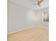 Bright bedroom featuring light wood floors, a ceiling fan, and a window with natural light at 13850 Amelia Pond Dr, Windermere, FL 34786