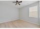 Bedroom with light wood floors and natural light provided by a single window at 13850 Amelia Pond Dr, Windermere, FL 34786