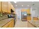 Kitchen with granite countertops, stainless steel appliances, and mosaic tile backsplash at 13850 Amelia Pond Dr, Windermere, FL 34786