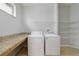 Convenient laundry room featuring countertop and storage shelving at 13850 Amelia Pond Dr, Windermere, FL 34786