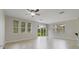 Spacious living room featuring tile flooring, ceiling fan, and sliding glass doors to yard at 13850 Amelia Pond Dr, Windermere, FL 34786