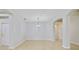 Open living room with neutral tile floors and modern chandelier lighting at 13850 Amelia Pond Dr, Windermere, FL 34786