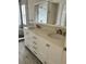 Bathroom featuring a double sink vanity with stone countertops and a tiled shower at 14147 Mailer Blvd, Orlando, FL 32828