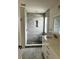Bathroom with a tiled shower, stone base, and modern vanity at 14147 Mailer Blvd, Orlando, FL 32828