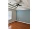 Bedroom featuring a tray ceiling, ceiling fan, and wood flooring for a comfortable living space at 14147 Mailer Blvd, Orlando, FL 32828