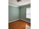 Bedroom with light green walls, wood flooring, and natural light through a window at 14147 Mailer Blvd, Orlando, FL 32828