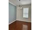 Bright dining room with hardwood floors and a modern chandelier lighting fixture at 14147 Mailer Blvd, Orlando, FL 32828