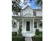 Charming home featuring a covered front porch with ceiling fans and neatly manicured landscaping at 14147 Mailer Blvd, Orlando, FL 32828
