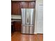 Well-equipped kitchen featuring stainless steel refrigerator and dark wood cabinets at 14147 Mailer Blvd, Orlando, FL 32828