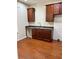 Kitchenette featuring wood cabinets, stone countertops, and hardwood floors at 14147 Mailer Blvd, Orlando, FL 32828
