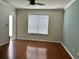 Bright living room with hardwood floors, a ceiling fan, and a view of the front yard at 14147 Mailer Blvd, Orlando, FL 32828
