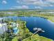 Scenic aerial view of resort community with lake, boat dock and community pool at 14501 Grove Resort Ave # 3239, Winter Garden, FL 34787