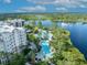Aerial view of the resort community showcasing a lake, landscaping, and community pools at 14501 Grove Resort Ave # 3239, Winter Garden, FL 34787