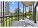 A screened balcony with seating offers an outdoor space to enjoy the lush greenery at 14501 Grove Resort Ave # 3239, Winter Garden, FL 34787