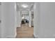 Bright hallway entrance leading to a living room with stylish furnishings and light wood flooring at 14501 Grove Resort Ave # 3239, Winter Garden, FL 34787