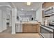 Bright, modern kitchen with stainless steel appliances, quartz countertops, and a view of the adjacent living space at 14501 Grove Resort Ave # 3239, Winter Garden, FL 34787