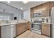 Well-equipped kitchen featuring stainless steel appliances, ample counter space, and a view into the living area at 14501 Grove Resort Ave # 3239, Winter Garden, FL 34787