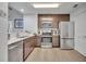 Contemporary kitchen with stainless steel appliances, wood-tone cabinets, and a convenient layout for cooking and entertaining at 14501 Grove Resort Ave # 3239, Winter Garden, FL 34787