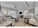 Comfortable living room featuring stylish furnishings, a ceiling fan, and access to the outdoors at 14501 Grove Resort Ave # 3239, Winter Garden, FL 34787