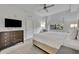Bright main bedroom featuring modern furniture, a large window and a television mounted on the wall at 14501 Grove Resort Ave # 3239, Winter Garden, FL 34787