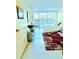 Bright bedroom with private balcony, desk, dresser, and sitting area at 151 E Washington St # 508, Orlando, FL 32801