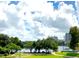 Scenic lake view showcasing park, buildings, blue sky, and fluffy white clouds at 151 E Washington St # 508, Orlando, FL 32801