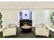 Inviting lobby with cozy seating around a fireplace, enhanced by modern decor and potted plants at 151 E Washington St # 508, Orlando, FL 32801