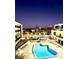 Nighttime view of a sparkling swimming pool surrounded by buildings and city lights at 151 E Washington St # 508, Orlando, FL 32801