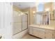 Bathroom features a glass-enclosed shower, a large mirror, and a well-lit vanity area at 1529 Farrindon Cir, Lake Mary, FL 32746