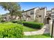 Inviting townhouse showcasing well-manicured greenery, a gated entrance, and classic architectural details at 1529 Farrindon Cir, Lake Mary, FL 32746