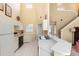 Efficient kitchen with sleek countertops and white tile flooring adjacent to stairwell at 1529 Farrindon Cir, Lake Mary, FL 32746