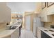 Functional kitchen featuring modern appliances, white cabinetry, and a view into the dining area at 1529 Farrindon Cir, Lake Mary, FL 32746