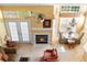 Spacious living room with a vaulted ceiling, cozy fireplace, and charming chandelier lighting at 1529 Farrindon Cir, Lake Mary, FL 32746
