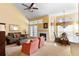 Bright and airy living room featuring a cozy fireplace and large windows at 1529 Farrindon Cir, Lake Mary, FL 32746
