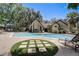 Community pool with a welcoming building and plenty of lounge chairs for relaxation at 1529 Farrindon Cir, Lake Mary, FL 32746