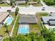 An aerial view showcases the property's screened pool, backyard, and neighborhood surroundings at 1736 Saxon Blvd, Deltona, FL 32725