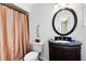 Bathroom featuring dark vanity, unique mirror, and a shower with curtain at 1736 Saxon Blvd, Deltona, FL 32725