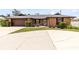 Charming single-story brick home featuring a well-manicured front yard and a two-car garage at 1736 Saxon Blvd, Deltona, FL 32725